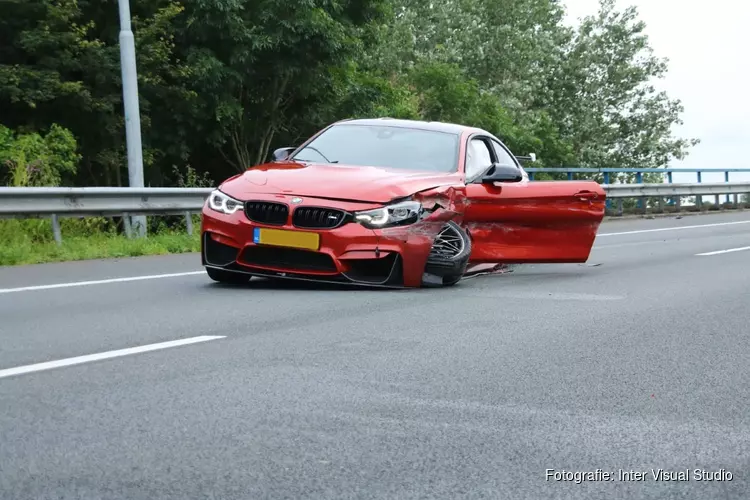 Sportwagen rijdt tegen vangrail op A8 bij Amsterdam, bestuurder gewond